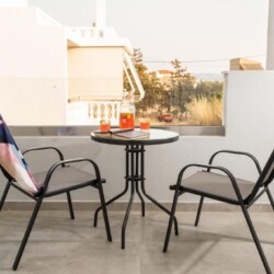 Cozy balcony with a table and chairs, perfect for relaxing outdoors