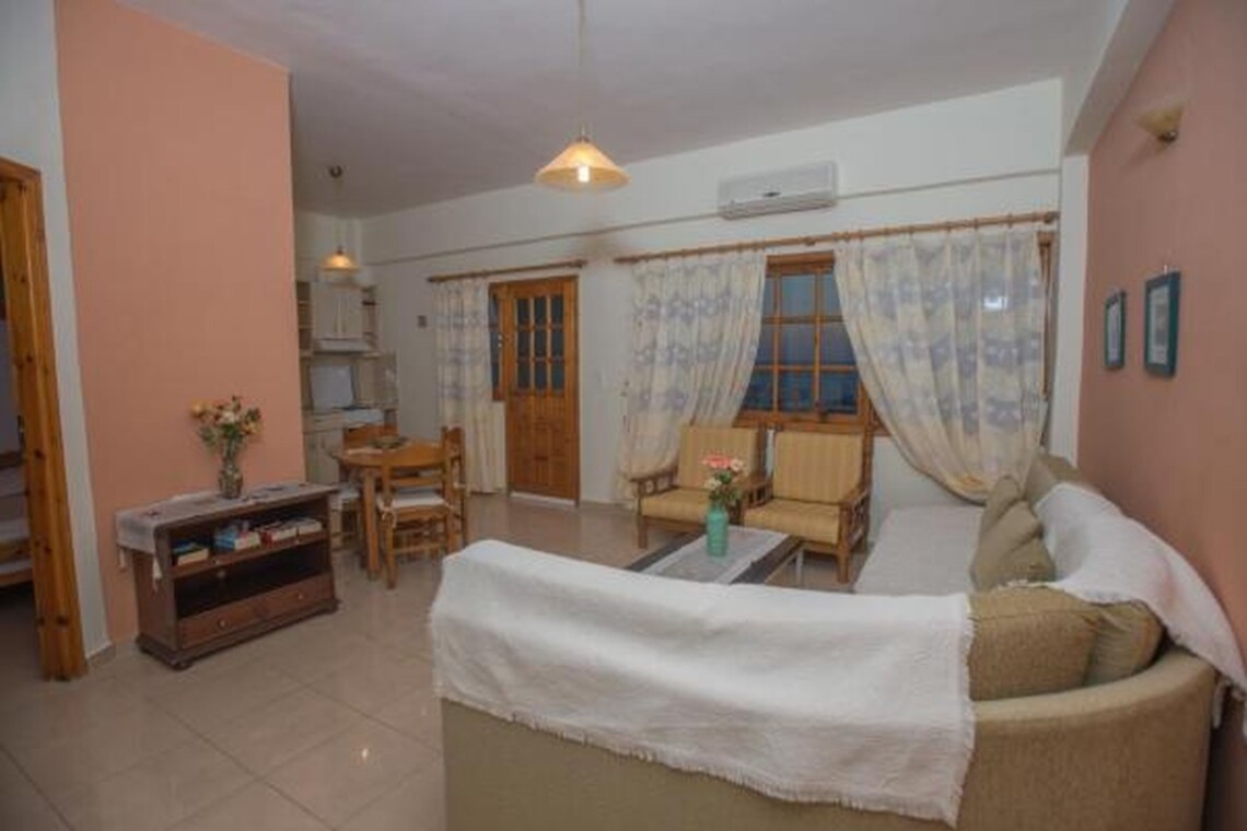 Living area with comfortable couch, sitting space, and sea view at Sunset Holiday Home, Neo Kalamaki