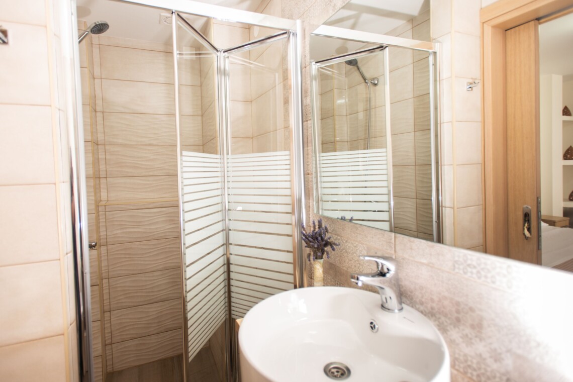 Modern bathroom with walk-in shower in beachfront studio in Matala, Crete